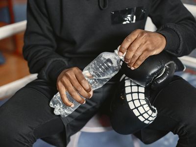 Person hands holding a water bottle during a break.